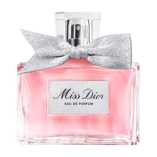 Pink perfume bottle with silver bow and 'Miss Dior' label on a white background