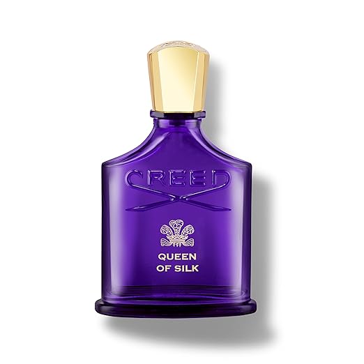 Purple Creed perfume bottle with gold cap on a white background
